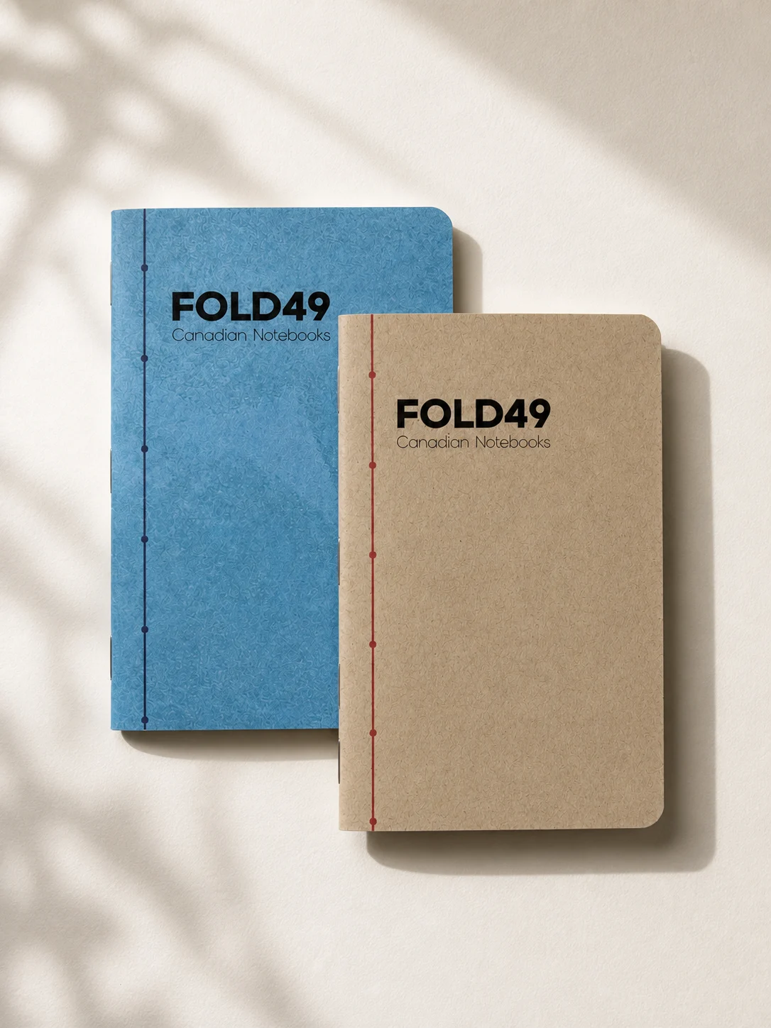 Blue and natural kraft FOLD49 notebooks with both front covers visible