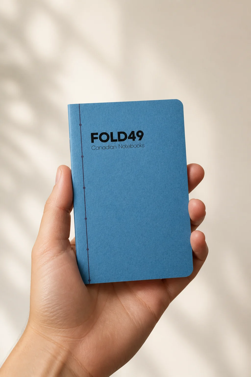 Blue FOLD49 standard pocket notebook held comfortably in one hand
